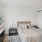 Spacious well-lit bedroom with a large window