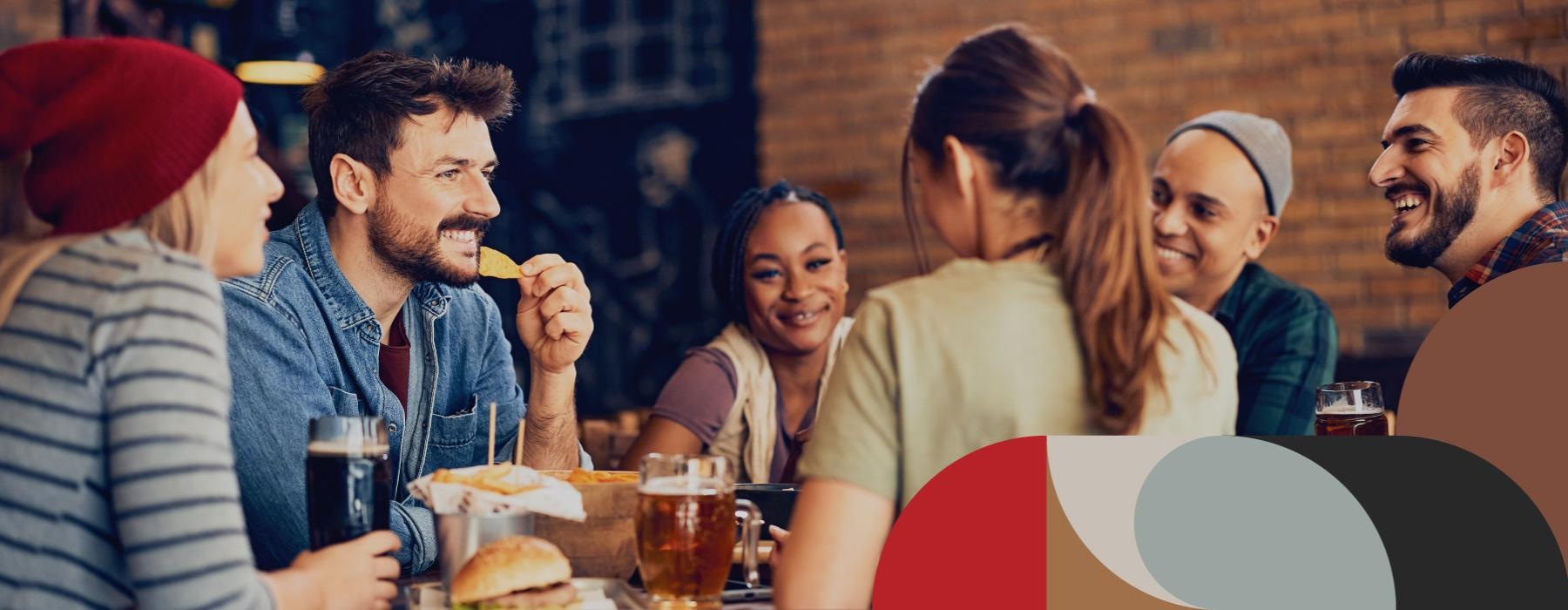 a group of people sitting at a table eating food