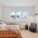 Bedroom with natural lighting and high ceilings