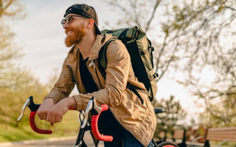 a person with a backpack riding a bicycle