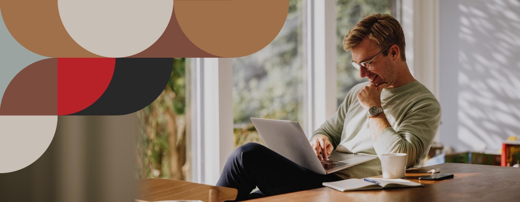 a person sitting at a table with a laptop